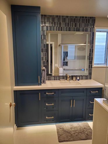 Navy blue vanity with tiled mirror wall