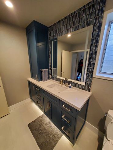 Navy blue vanity with under-cabinet lighting