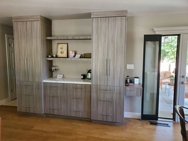 Gray wood-grain built-in with tall cabinets and open shelves