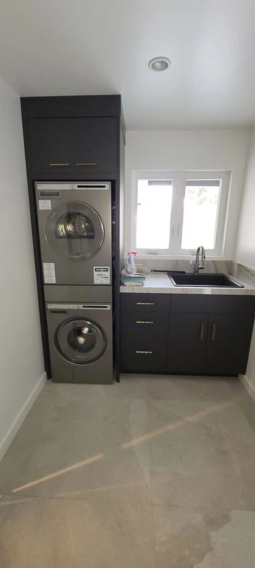 Laundry room with stacked washer and dryer