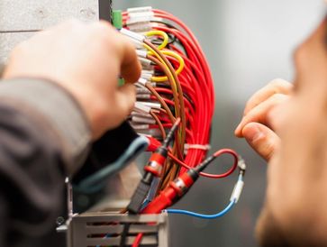 Electrician engineer tests electrical installations and wires on relay protection system
