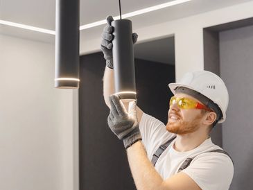 Electrician working safely on switches and sockets of a residential electrical system