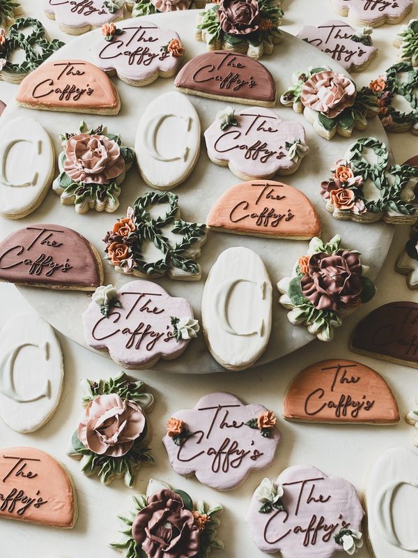 Elegant decorated cookies with floral designs and "The Caffy's" text.