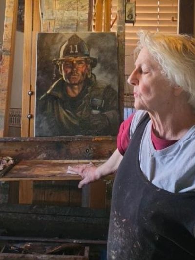 Elderly woman with a firefighter portrait.