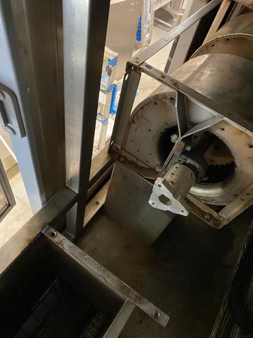 Close-up of a metallic mechanical part inside an industrial machine.