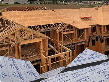 Large wooden framework for a multi-story building under construction.
