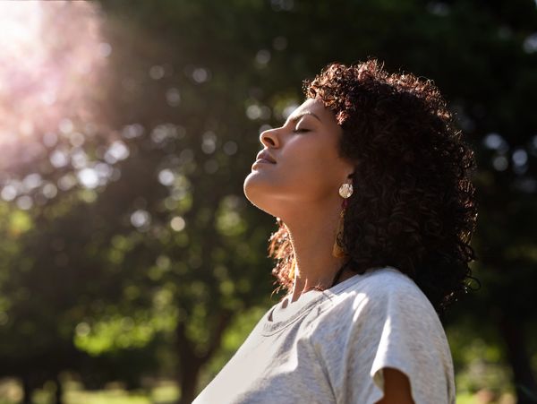 A woman meditating outside