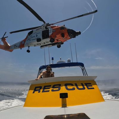 lifeguard rescue boat with USCG helicopter above