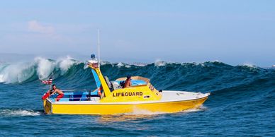 lifeguard rescue boat going through surf