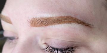 Close up of a strawberry blonde powder brow freshly done