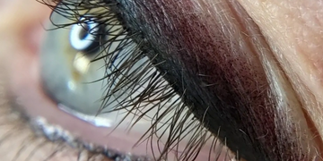 macro image of shaded permanent eyeliner on left eye