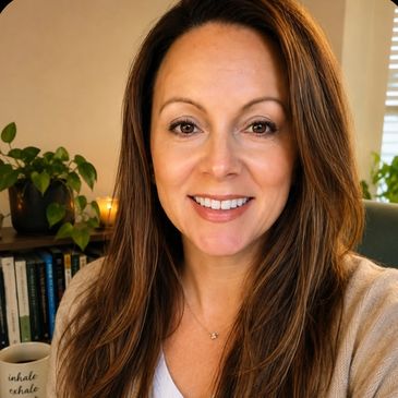 Smiling woman with long brown hair indoors.