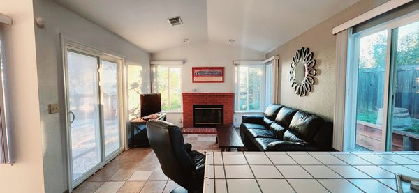 Cozy family room with a wood burning fireplace and access to  the back yard.
