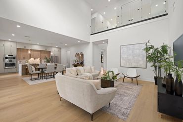 Modern open-concept living and kitchen area with neutral tones.