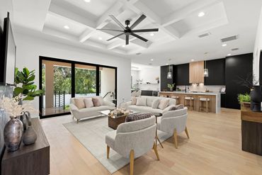 Modern living room and kitchen with neutral colors and natural light.