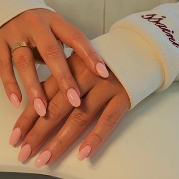 Hands with pink polished nails.