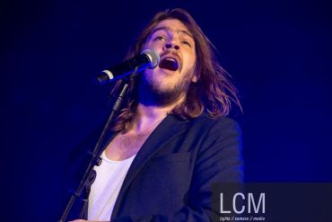 Male singer passionately performing on stage.