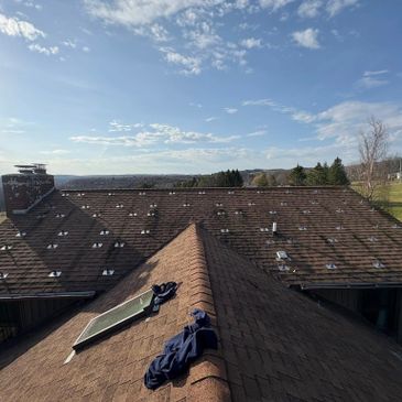 View of a rooftop with clothes and a scenic sky.