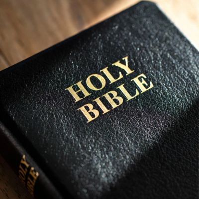 Close-up of a black leather-bound Holy Bible with gold lettering.