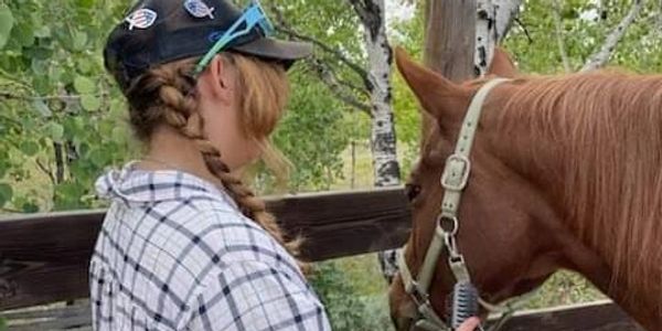 Girl combing horse’s mane, Eagle’s Nest Youth Ranch 