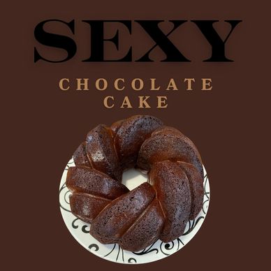 A rich, moist chocolate cake styled as a bundt on a decorative plate.