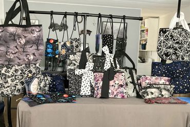 Assorted bags on table. Prices vary by item. 