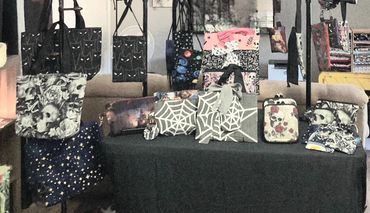 Table arrangement of market bags and book / tablet sleeves.