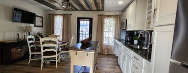 Cozy kitchen and dining area with rustic wooden furniture and bright natural light.