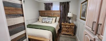 Cozy bedroom with rustic wooden furniture and green accents.