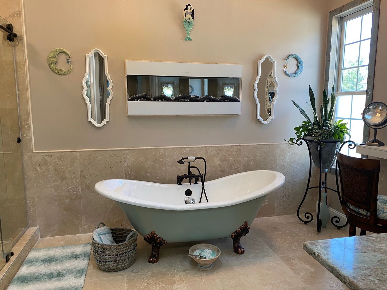 Claw foot bathtub with spa decor in large master bathroom