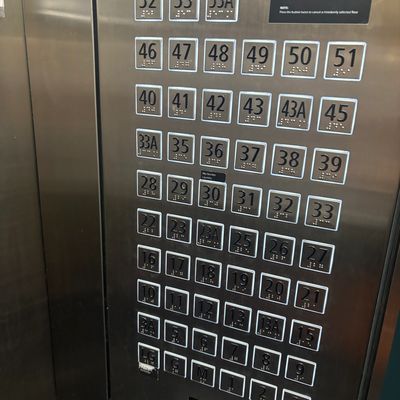 Elevator panel with floor buttons arranged in an irregular order.