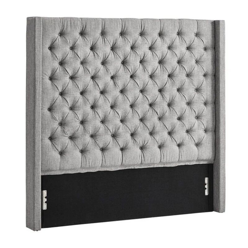 Gray tufted upholstered headboard with wingback design.
