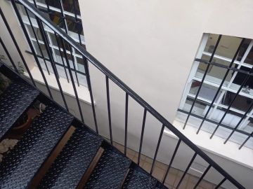 Black metal staircase with window bars