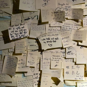 Wall covered with numerous handwritten notes on sticky notes.