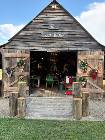Rustic barn entrance decorated with flowers.