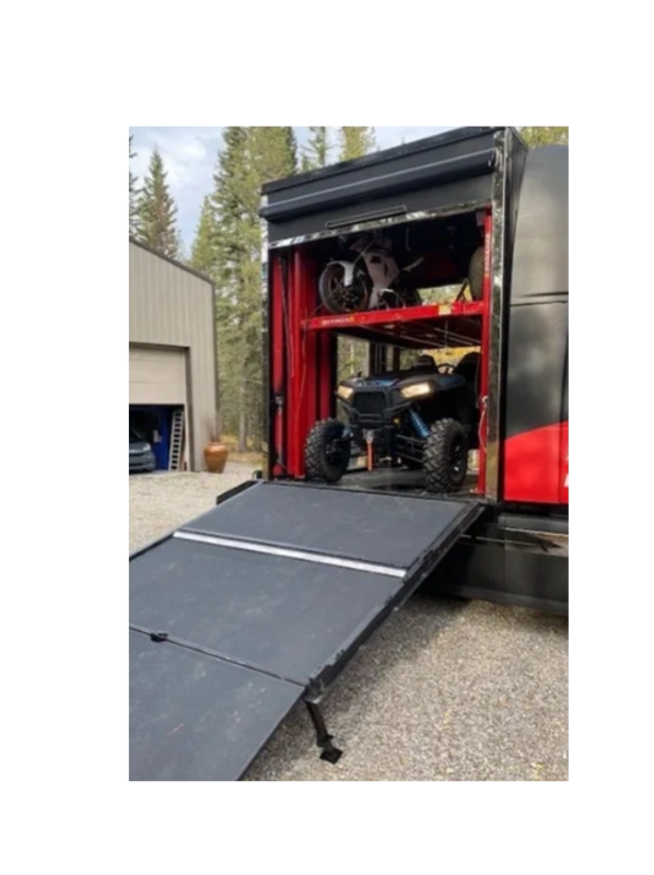 Polaris RZR1000S side by side inside HDToy Box on lower floor with motorcycles on the 2nd level lift