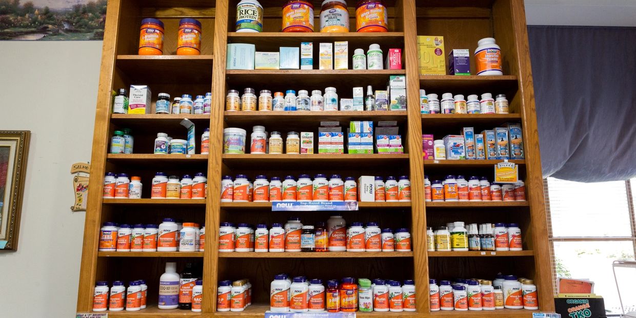 Nutritional supplements stacked on shelf.