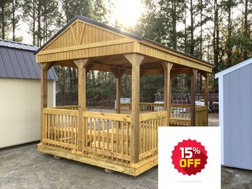 Wooden gazebo structure with a peaked roof in an outdoor setting.