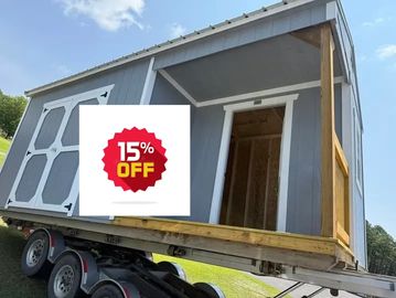 A small gray shed on a trailer ready for transport.