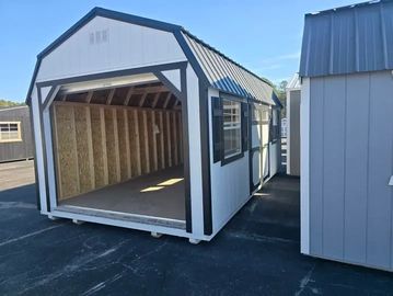 Two gray outdoor storage sheds with white trim and blue roofs.