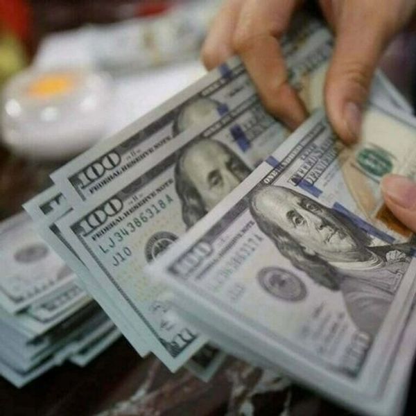 Person counting $100 bills by hand.