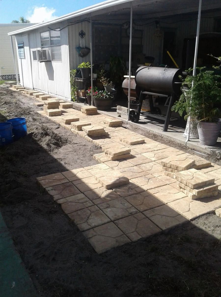 Pavers and bricks laid out for a patio renovation