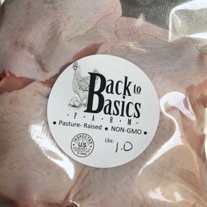 Packaged raw chicken from Back to Basics Farm with pasture-raised, non-GMO label.