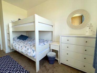 a beautiful bedroom with a bunk bed for the kids, with views to the sea