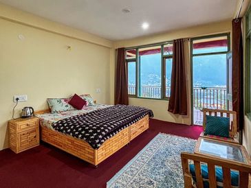 Cozy bedroom with mountain view and balcony.
