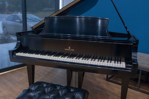 A black Steinway &amp; Sons grand piano.