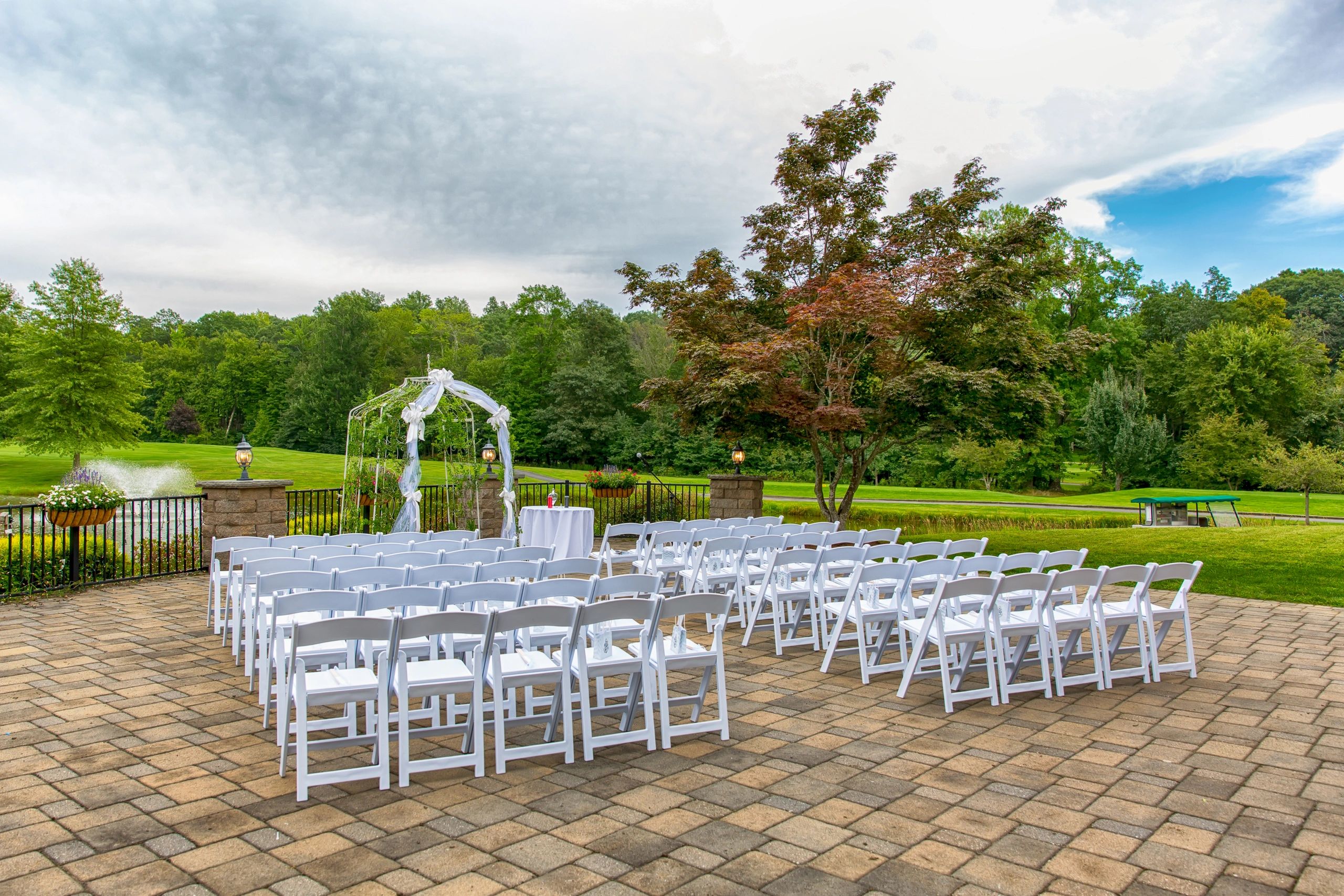 Wedding Ceremony with White Chairs