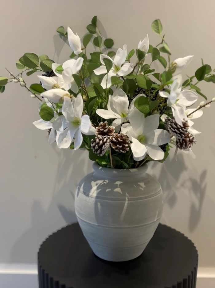 A beautiful arrangement featuring elegant white magnolia blooms