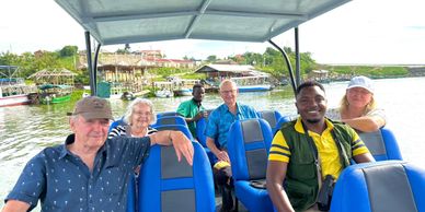 A group of six people enjoying a boat ride on a sunny day.