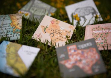 Decorative cards featuring U.S. states placed on grass.
